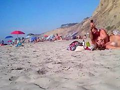 2 girls make fun with a guy's microdick on a nudist beach