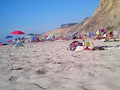 2 girls make fun with a guy's microdick on a nudist beach